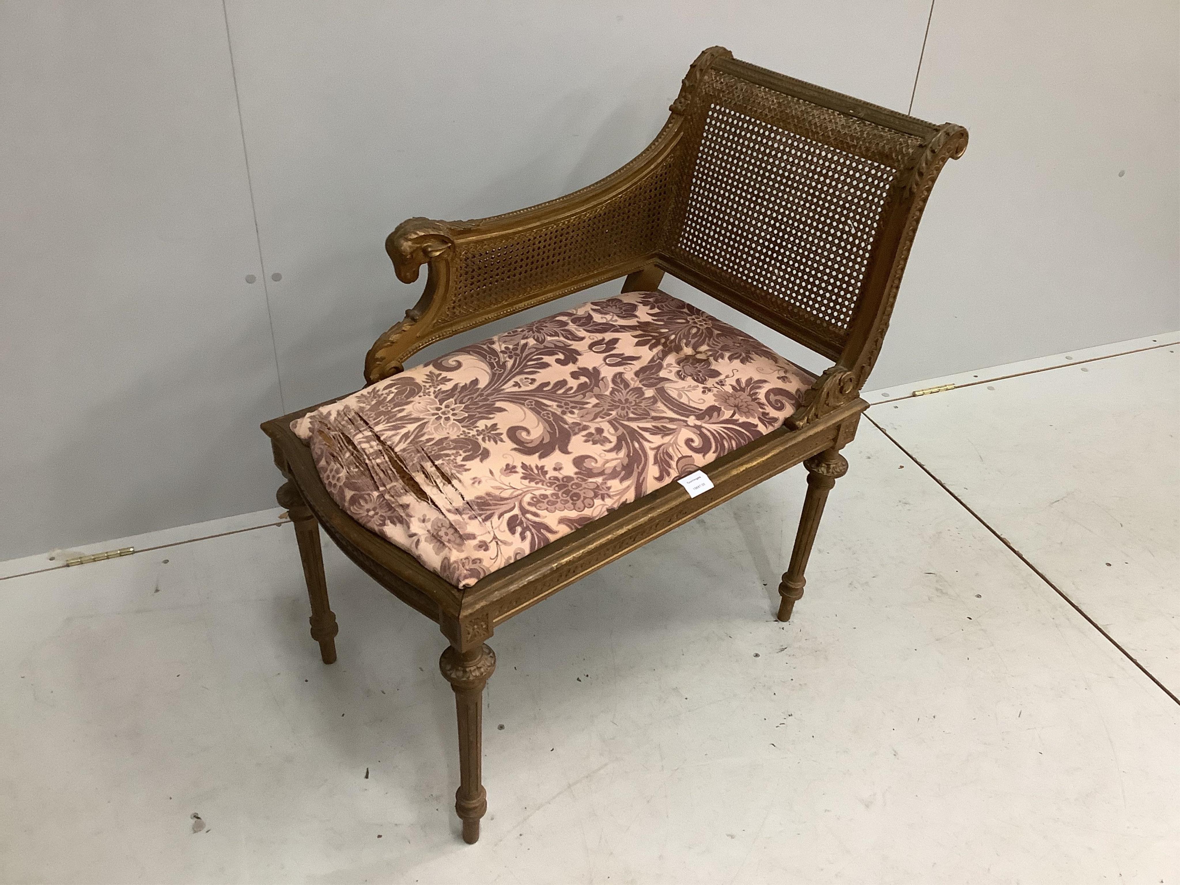 A Louis XVI style painted and giltwood caned seat, width 75cm, depth 44cm, height 84cm. Condition - fair